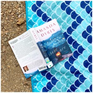 book on a blanket on the sand