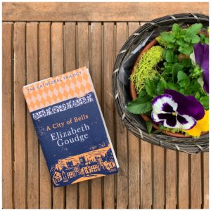 book on table with pansies