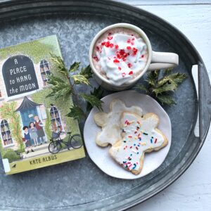 book with mug of hot chocolate and sugar cookies